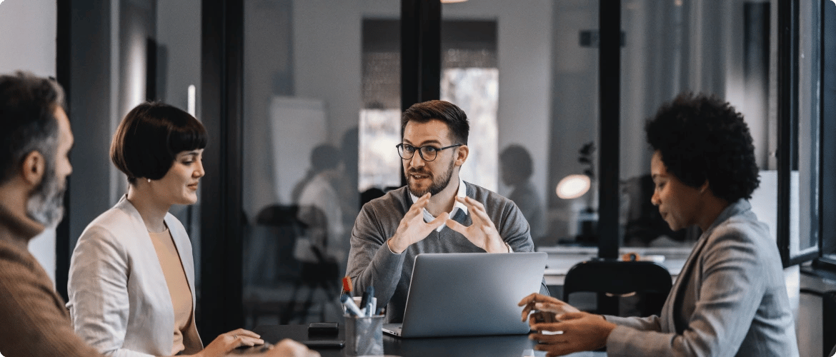 senior-manager-is-sitting-boardroom-with-multiracial-colleagues-discussing-project (1)