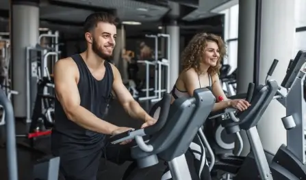 attractive-young-woman-her-trainer-running-treadmill-gym (1)