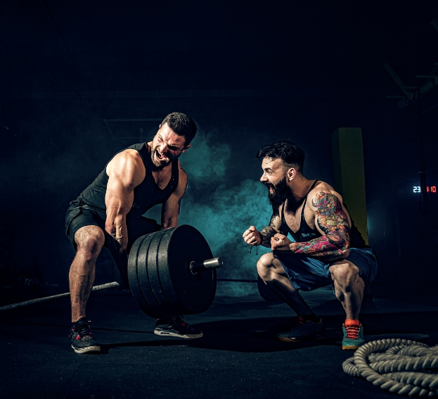 two-muscular-bearded-tattoed-athletes-training-gym